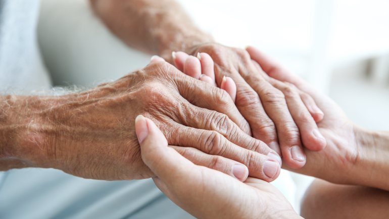 Two people holding hands