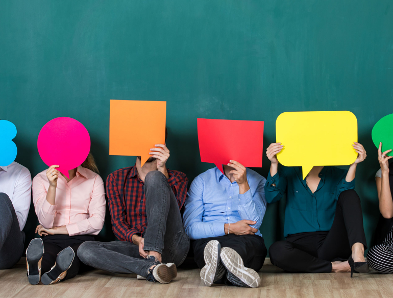People sitting on floor with coloured speech bubbles Credit: Shutterstock