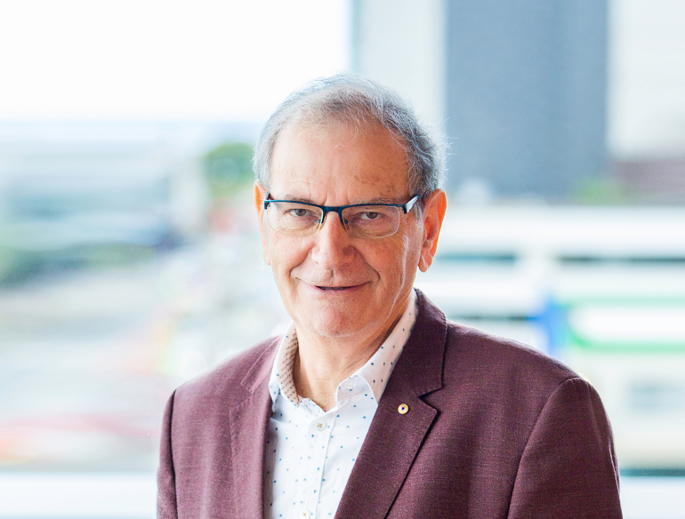 Professor David Cooper AC, standing on balcony. Credit: Kirby Institute/Bec Lewis.