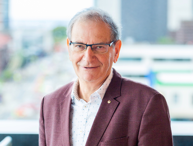 Professor David Cooper AC, standing on balcony. Credit: Kirby Institute/Bec Lewis.