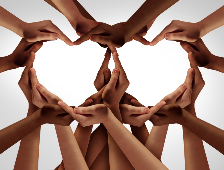 Several diverse coloured hands, forming the shape of two hearts. Credit: Shutterstock