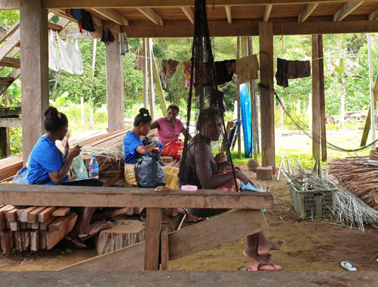 Team of women field workers talking about mass drug administration on intestinal worm infections in Solomon Island.