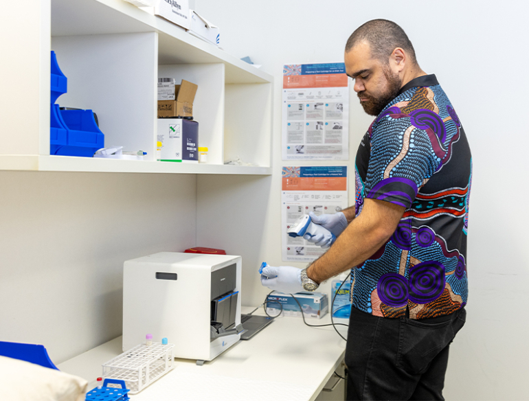 Glen Duncan using Pint-of-care machine diagnostics aboriginal artwork shirt