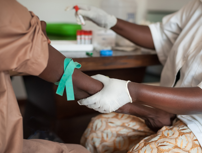 African nurse drawing blood from a patient. Credit: Shutterstock.