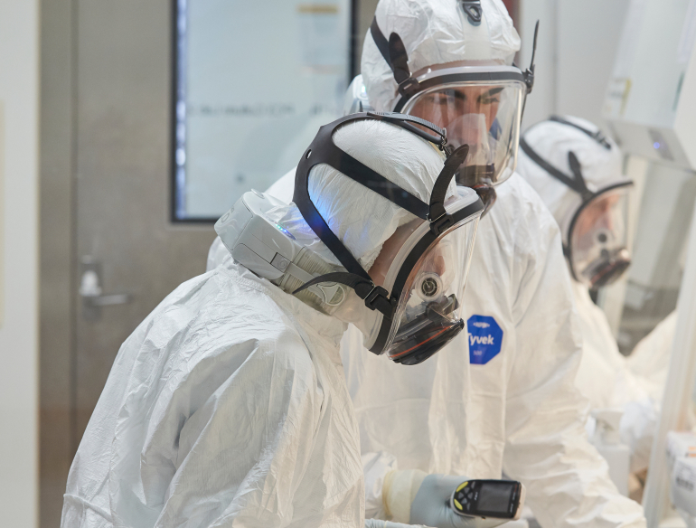 Lab scientists in full PPE working on COVID Omicron research in PC3 containment lab. Credit: UNSW/Richard Freeman