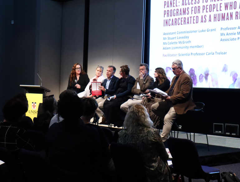 Group of panelists on stage, in front of audience for World Hepatitis Day special event, 2019. 