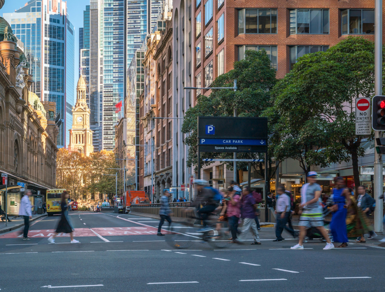 Pedestrians walking across a street in Sydney. Credit: AdobeStock