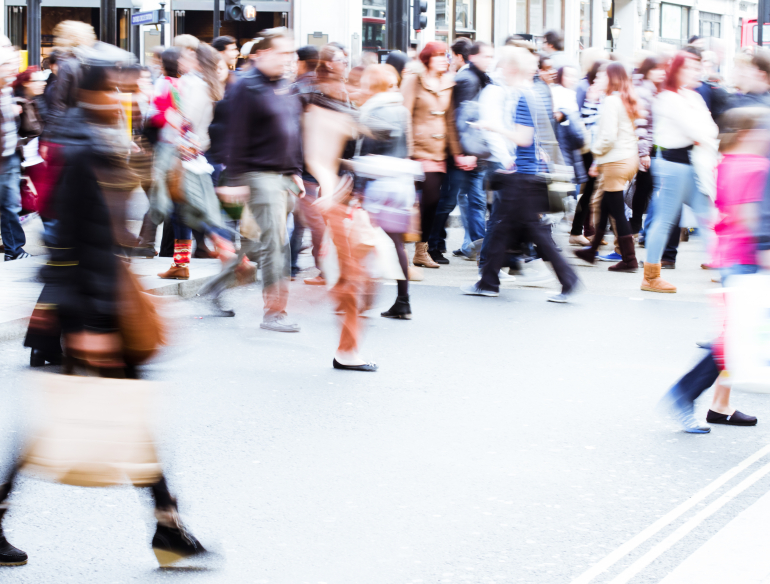 Group of people walking, blurry pedestrians. Public health surveillance. Credit: AdobeStock