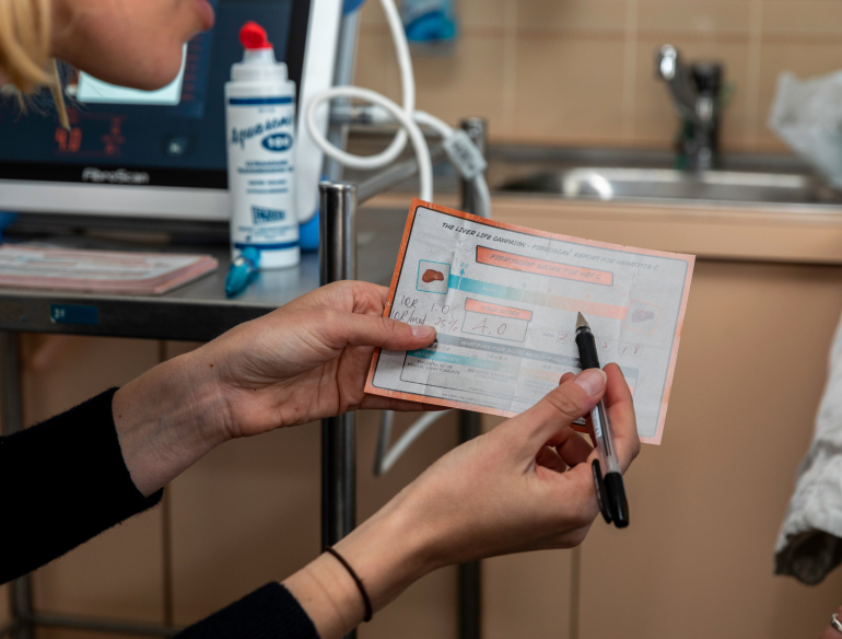 Research explaining fibroscan, hepatitis C result to a participant at a clinic. Credit: Bec Lewis