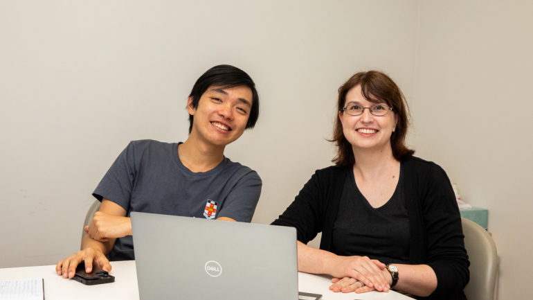 Two Kirby Instiute staff researchers smiling at the camera, in a meeting room. Credit: Kirby Institute/Bec Lewis
