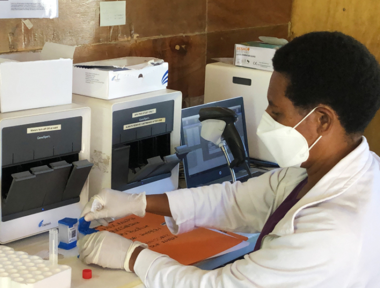DNU. Woman technician testing a sample at Papua New Guinea women's clinic.