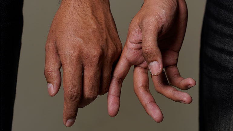 Two men holding hands
