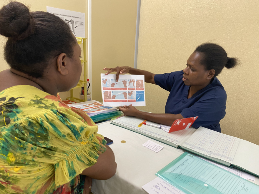 Midwife Elvie provides education to a woman on self-collection for screening Vanuatu