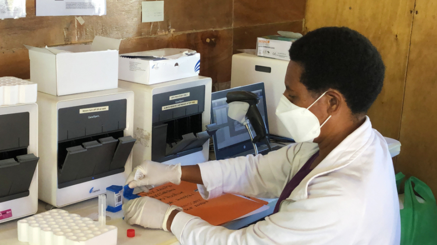 DNU. Woman technician testing a sample at Papua New Guinea women's clinic.