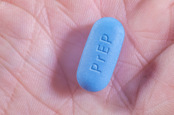 A PrEP pill in the palm of a hand