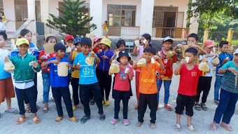 School children with stool collection packs for clinical trial project looking into deworming program in Vietnam. Credit: Dinh Ng Nguyen