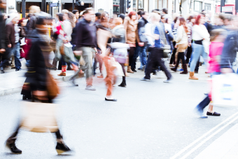 Group of people walking, blurry pedestrians. Public health surveillance. Credit: AdobeStock