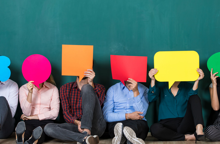 People sitting on floor with coloured speech bubbles Credit: Shutterstock