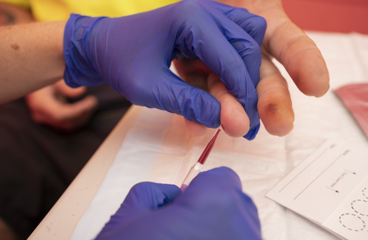 A fingerstick blood sample is collected for a point-of-care test