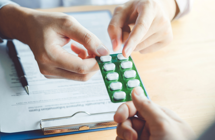 Doctor giving a patient blister pack of pills. Credit: AdobeStock