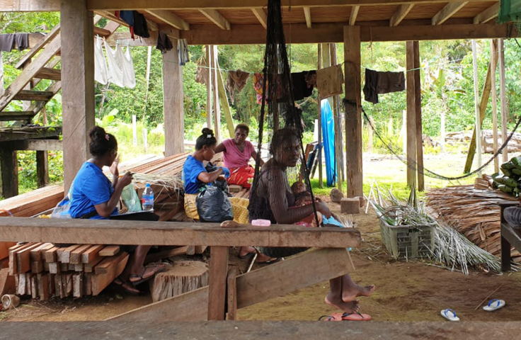 Team of women field workers talking about mass drug administration on intestinal worm infections in Solomon Island.