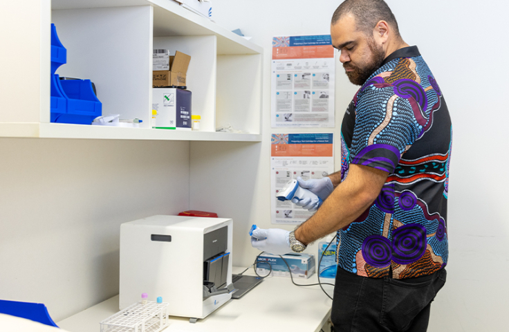 Glen Duncan using Pint-of-care machine diagnostics aboriginal artwork shirt