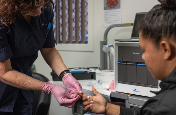 Woman nurse examining finger of Aboriginal woman at a clinic. Credit: Thunderbox Films