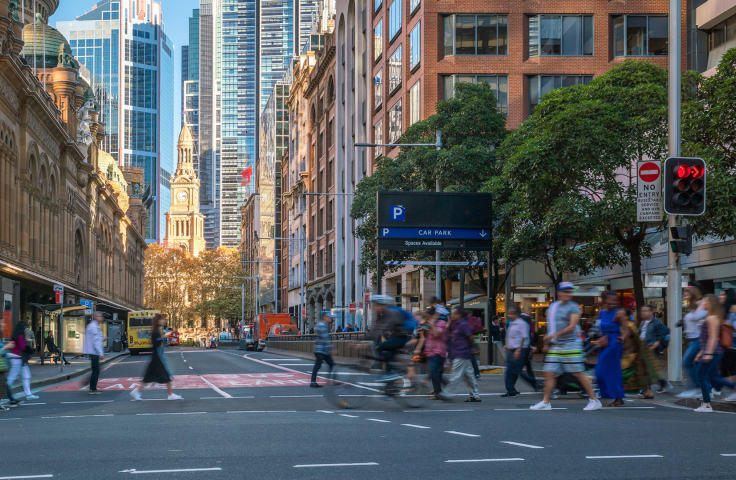 Pedestrians walking across a street in Sydney. Credit: AdobeStock