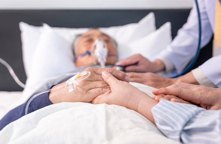 scene of a wife holding hands hopeless senior male patient who have oxygen and intravascular solution drip lying on bed,doctor examining a dying patient,concept of palliative care,end of life care