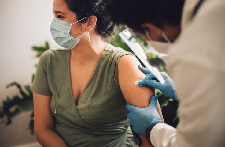 Doctor giving a vaccination to a woman. Credit: AdobeStock